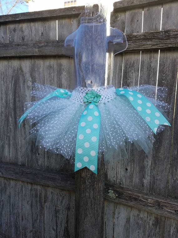 White and aqua tutu with grosgrain ribbon accents. One size fits most toddler girls