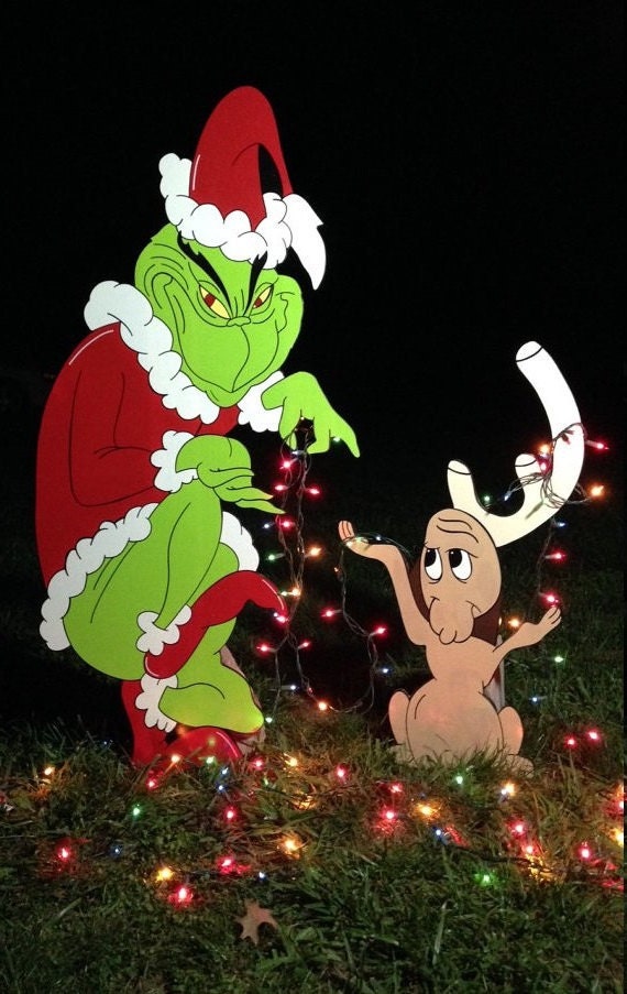 Grinch yard art with max..stealing the lights