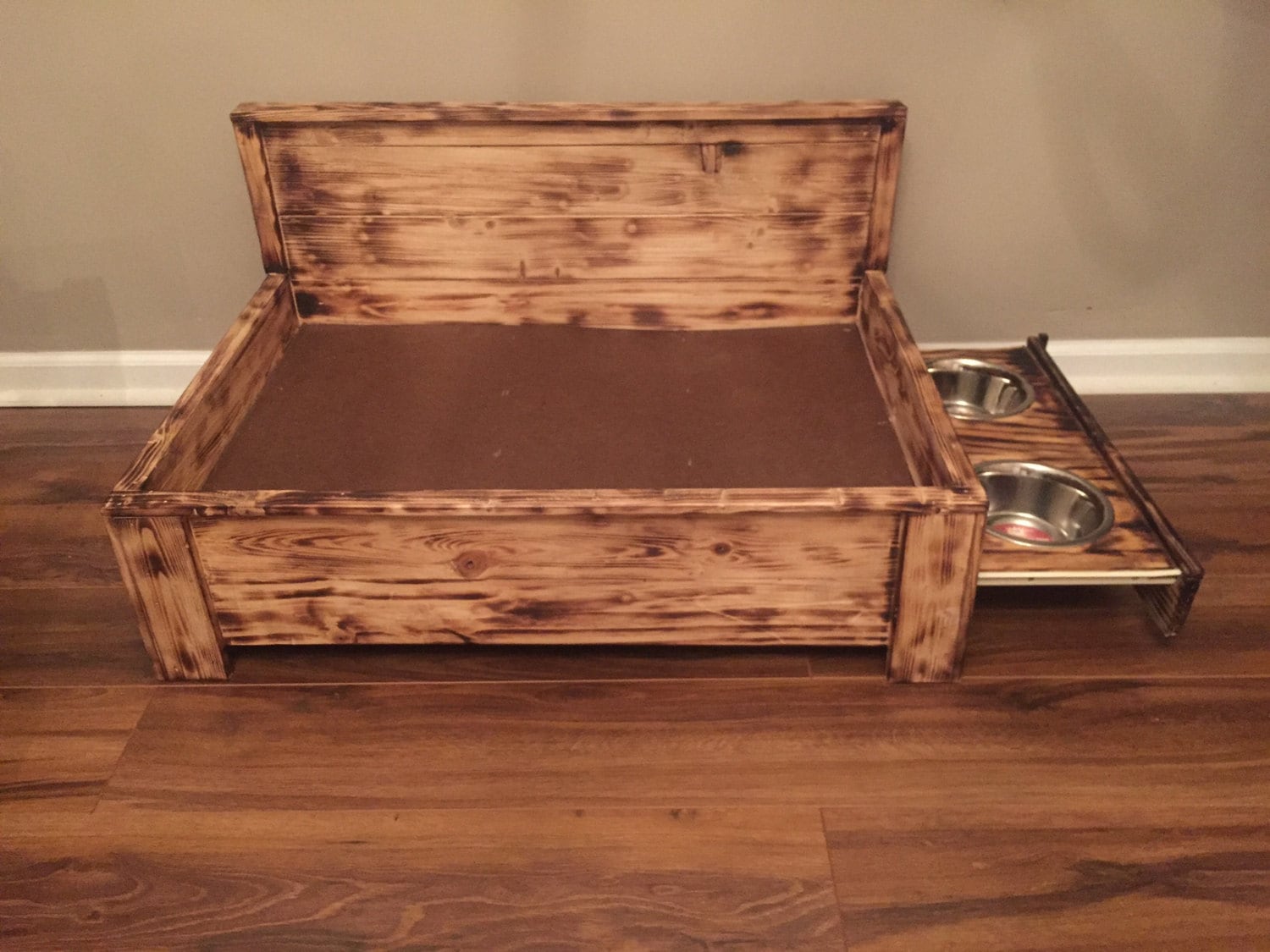 Rustic wood dog bed with pull out feeding station Raised dog