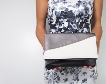 oversized fold over clutch in color block faux leather with choice of zipper color. Holiday clutch.