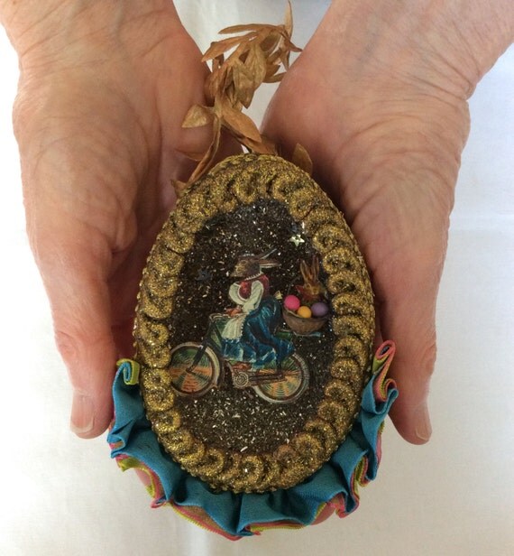 Hanging Easter egg with antique image of rabbit on bicycle