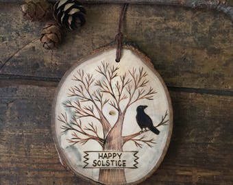 Wood burned Happy Solstice ornament or wall hanging. Available with or without raven.