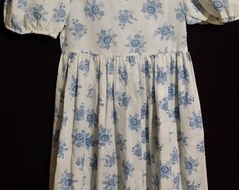 Adorable little girl vintage dress by RUTH, adorned with blue bouquets.