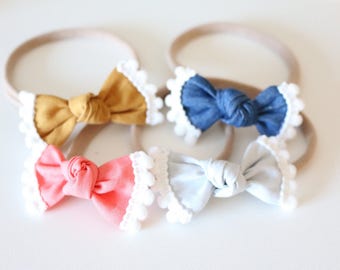 Pom pom trim bows/ cute baby bows/ baby headbands/ newborn headbands/ nylon headbands/ little baby bows/ cute baby headbands/ trendy bows