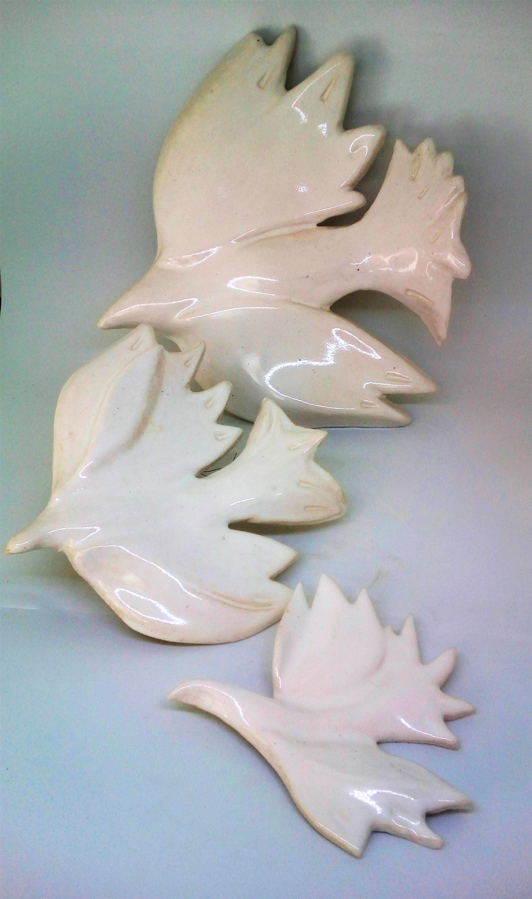 Three white doves . Hanging on the wall sculpture.Wall decor