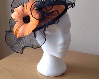 Black and Orange Sinamay Fascinator with a wave of pleated crin with a feather flower on a Band Weddings Races, Royal Ascot,Kentucky Derby