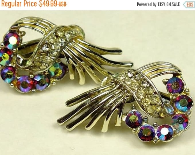 Storewide 25% Off SALE Vintage Designer CORO Gold Tone Cross Bow Earrings Featuring Sparking Magenta Aurora Borealis Stones Among Baguette D