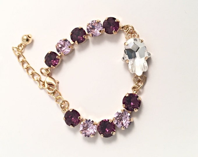 A perfect stylish gift! Swarovski® crystal protective Hamsa Hand of Fatima light and dark purple amethyst crystal tennis bracelet.