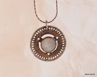 pendant with moonstone. Suspension of items from old clock, a ring of Sterling Silver