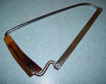 Vintage Bakelite Meat frozen food saw.