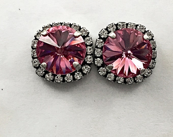 Glamorous pink lady timeless and classic Swarovski® crystal stud earrings in light rose pink surrounded by a halo of pave crystals.