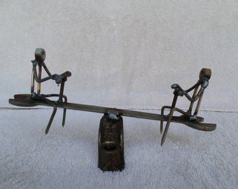welded scrap metal seesaw teeter totter sculpture