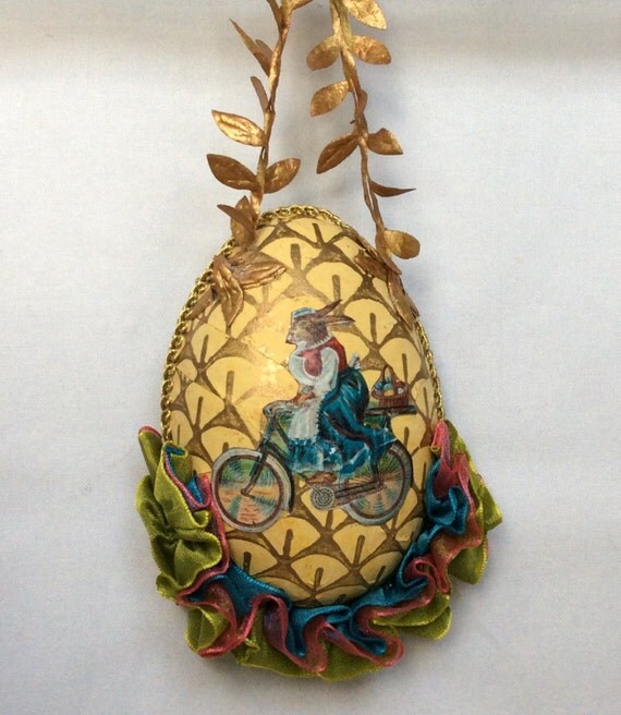 Hanging Easter egg with antique image of rabbit on bicycle