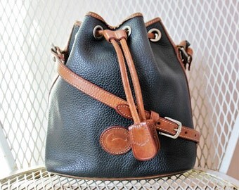 Vintage Dooney And Bourke Black And Tan All Weather Leather Small Drawstring Bucket Bag Shoulder Bag Made In USA