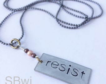 RESIST necklace in pewter with copper detail.