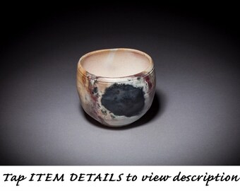 Wheel thrown and altered, pit fired smoke fired stoneware ceramic pottery clay vessel bowl with sprayed acrylic waterproofing