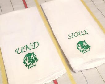 4 green on white UND fighting sioux kitchen towels. Flour sack university norh dakota ND