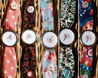 Female fabric watch. Clock with sphere of hearts swirling. Clock of fabric of different colors.