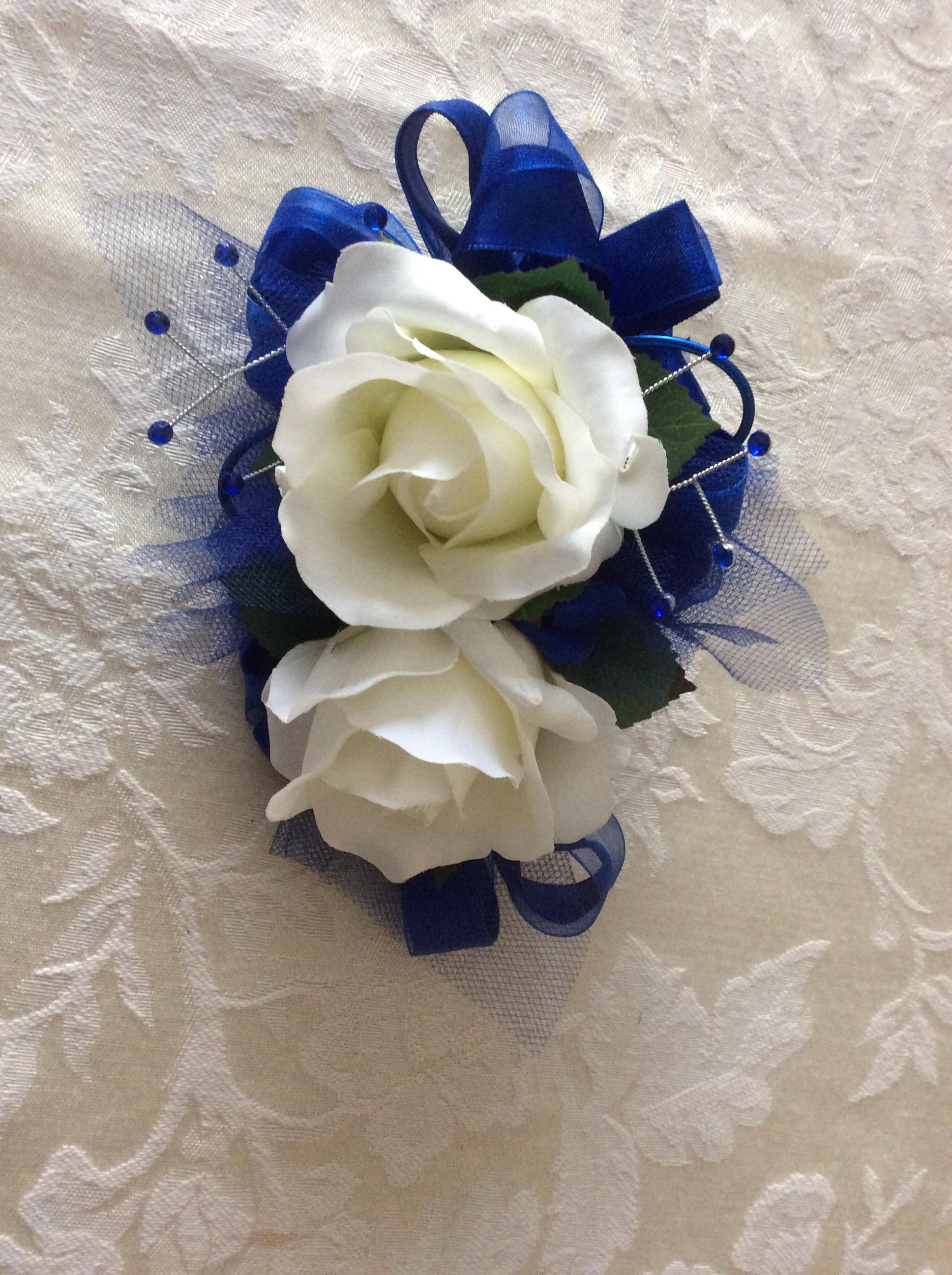 2 Piece wrist corsage and boutonniere in white roses and dark