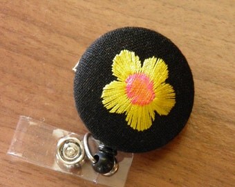 Embroidered flower badge reel