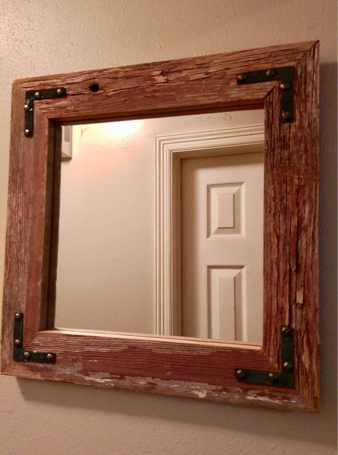 Reclaimed barnwood mirror with accent brackets