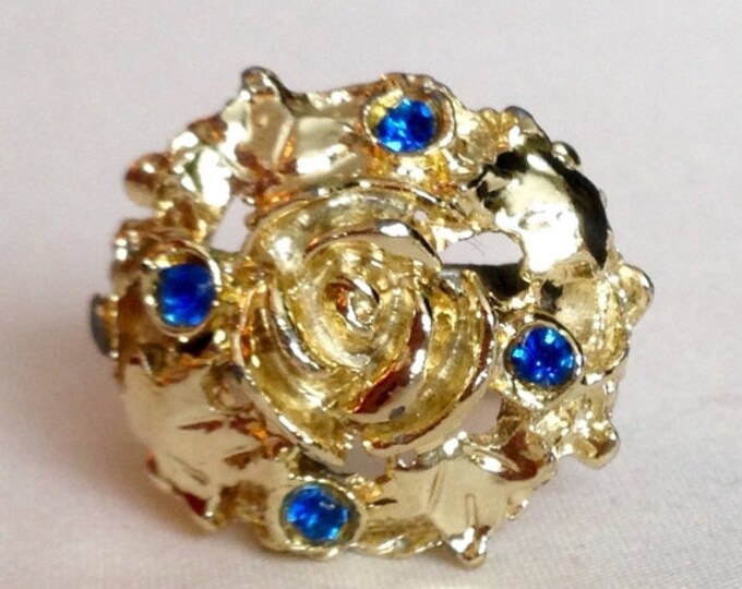 Storewide 25% Off SALE Vintage Gold Tone Rose Dome Centered Designer Ring Featuring Blue Rhinestone Accents With Open Design