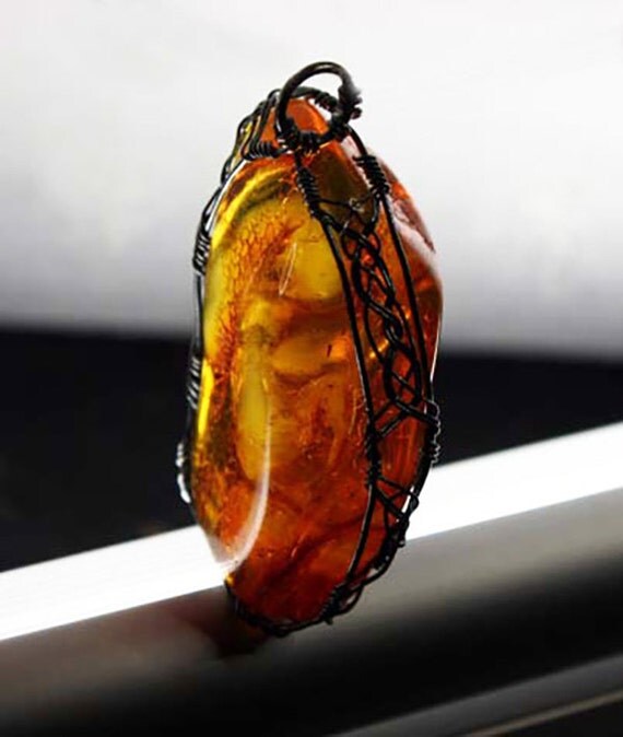 Baltic amber wrapped Celtic style with sterling silver