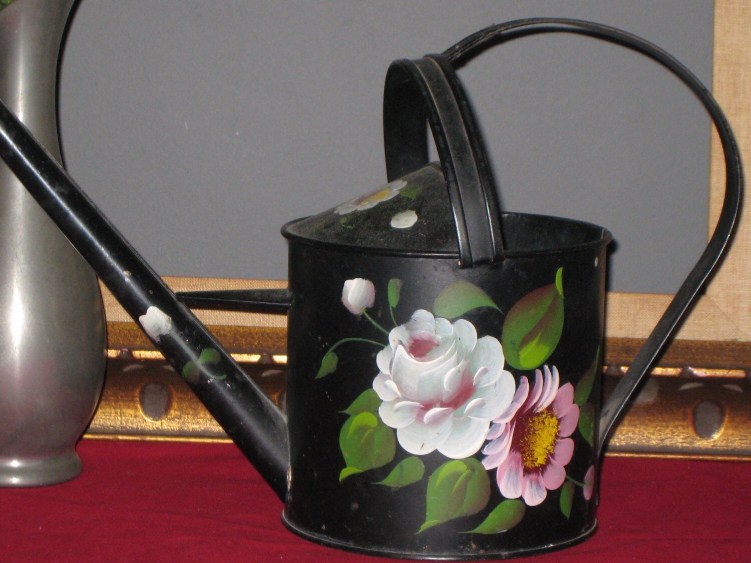 painted metal watering can        
        <figure class=