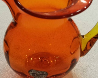 Vintage Orange Amberina Blown Glass Pitcher by Rainbow Glass of Huntington, W.V. 6" tall and wide. Applied handle. No damage. Very Clean.
