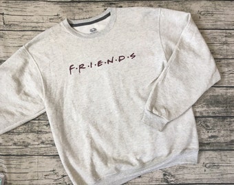 Friends Title Sweatshirt. From the popular TV show "Friends" get this cozy show name sweatshirt! Light heather grey shirt with maroon