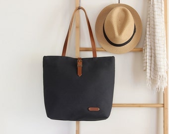 Dark navy tote / diaper bag / shoulder bag, leather handles, 9 inside pockets. Waterproof lining available