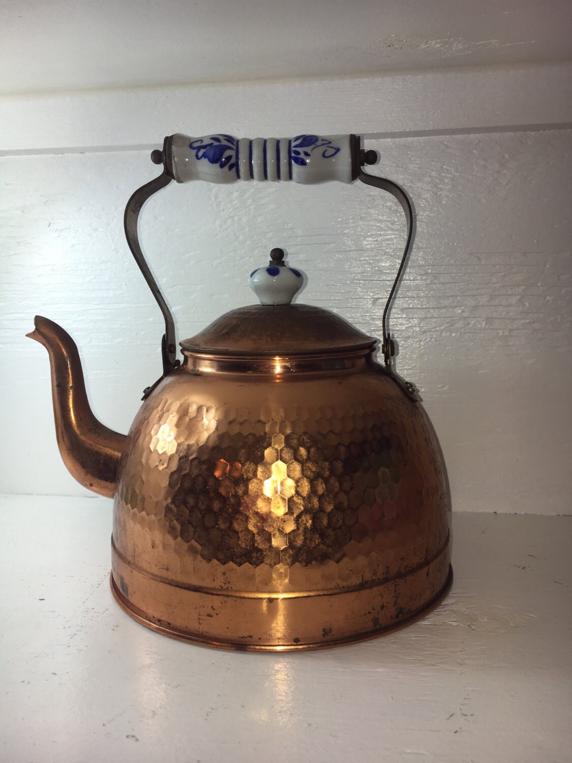 copper teapot with glazed blue and white handle