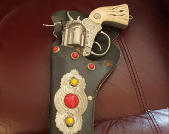 Vintage restless toy gun and holder