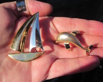 Lot of 2 vintage NAUTICAL Gold t. brooches: SAILBOAT & DOLPHIN, signed Gerrys and Best