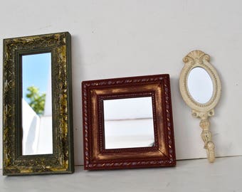 Two decorative mirrors and a hanger with mirror