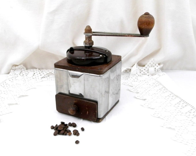 A vintage Peugeot coffee grinder with bakelite lid kitchenware