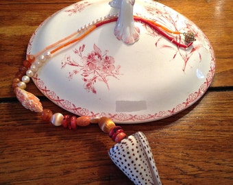 A very long summer orange, red, pink, white necklace with shelfs, bambou de mer, silk, various kinds of coral, carneool and a magnet clasp