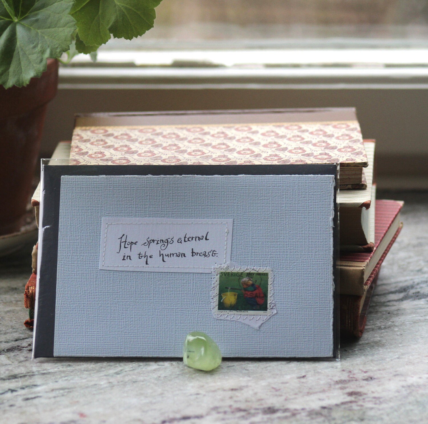 Hope springs eternal in the human breast Pale blue card with