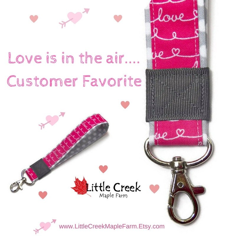 Pink script LOVE wristlet keychain on gray polka dot