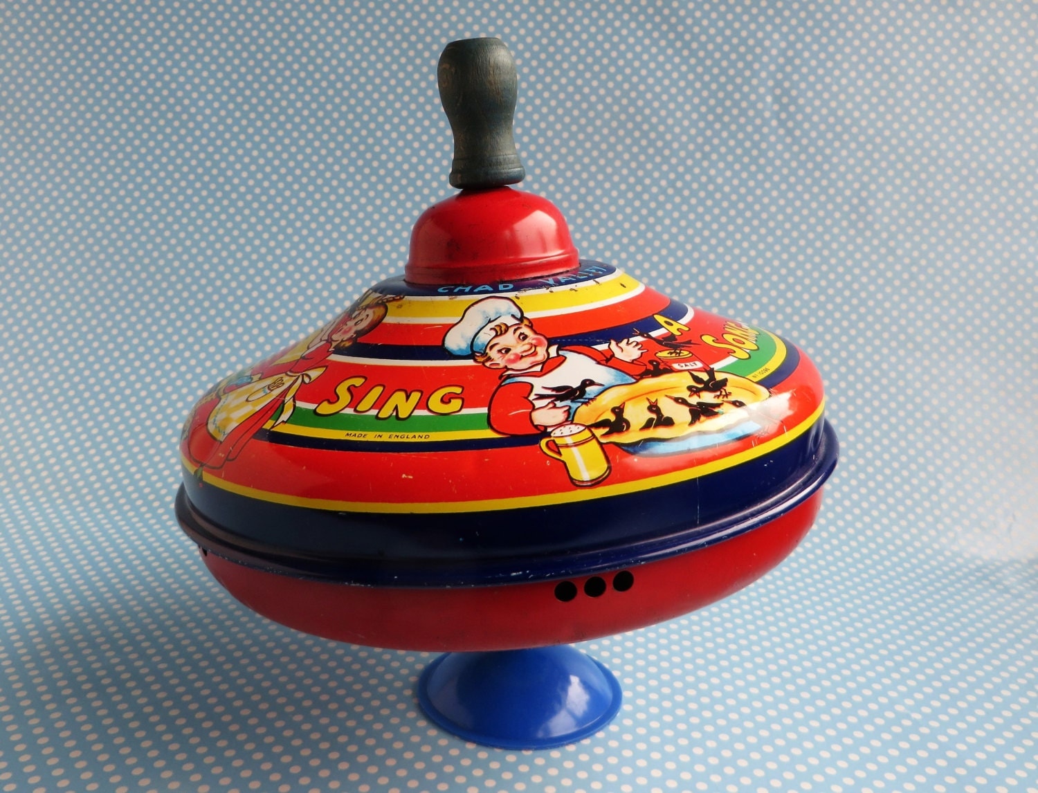 Vintage metal spinning top toy by Chad Valley with a wooden