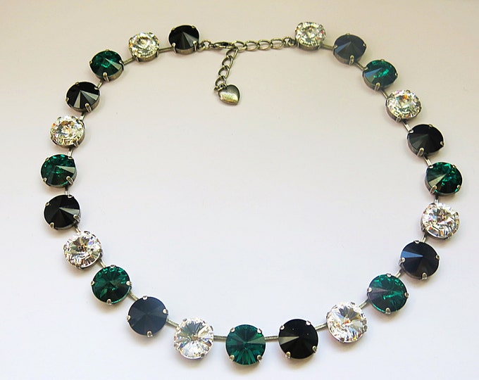 Feel glamorous and confident in this statement necklace made with genuine Swarovski® crystals in emerald green, clear and jet black.