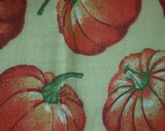 1 yard of Pumpkins on tan fabric 35 inches wide