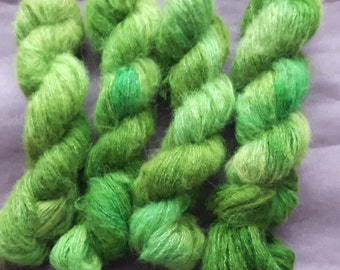 A skein of hand dyed yarn, baby suri alpaca x merino x bamboo, Shades of Green and some Pastel Turquoise