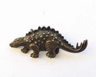 brass dinosaur figurine