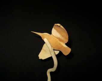 Wooden carving of a Wallcreeper yew on support branch in Holly