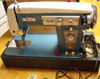 vintage sewing machine,Super Deluxe,Ferguson,made in Japan,motor made in Tokyo,blue and cream color,chrome accents,carry case,retro sewing