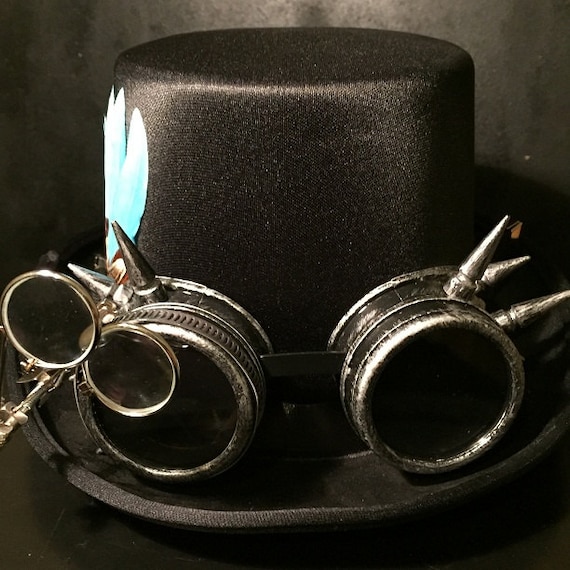 Black Steampunk Top Hat, Cyber Punk, Retro, With Silver Effect Spikey Goggles, With Eye Loupes And Turquoise Goose Feather by Steampunkbyben steampunk buy now online Black Steampunk Top Hat, Cyber Punk, Retro, With Silver Effect Spikey Goggles, With Eye Loupes And Turquoise Goose Feather by Steampunkbyben steampunk buy now online