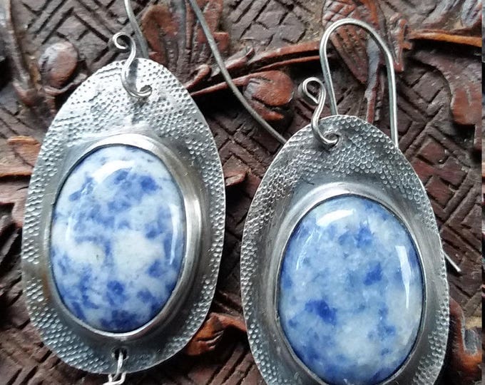 Earrings with Blue Denim Cabochons Set in Sterling Silver and Hand Stamped. The dangle is a pale Blue Iolite