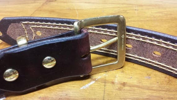 Custom belt beeswax and oil soaked. Brass rivets gold