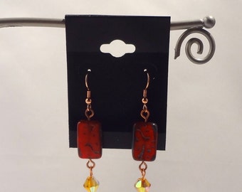Red Picasso rectangle bead on copper earwire. Amber glass bead dangle